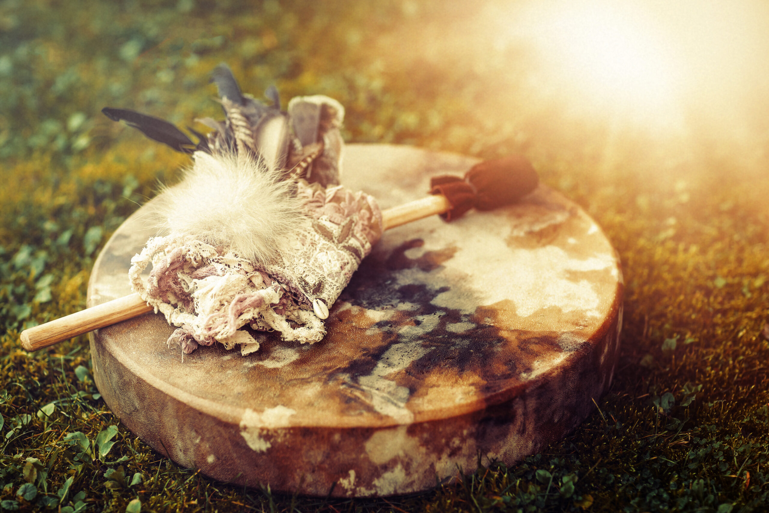Shamanic,Drum,And,Shamanic,Feathers,On,Denim.